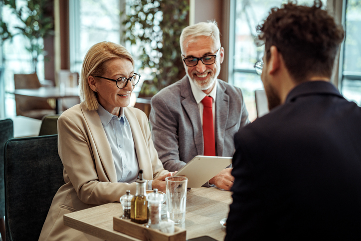 A senior couple reviewing their retirement plan with an advisor.