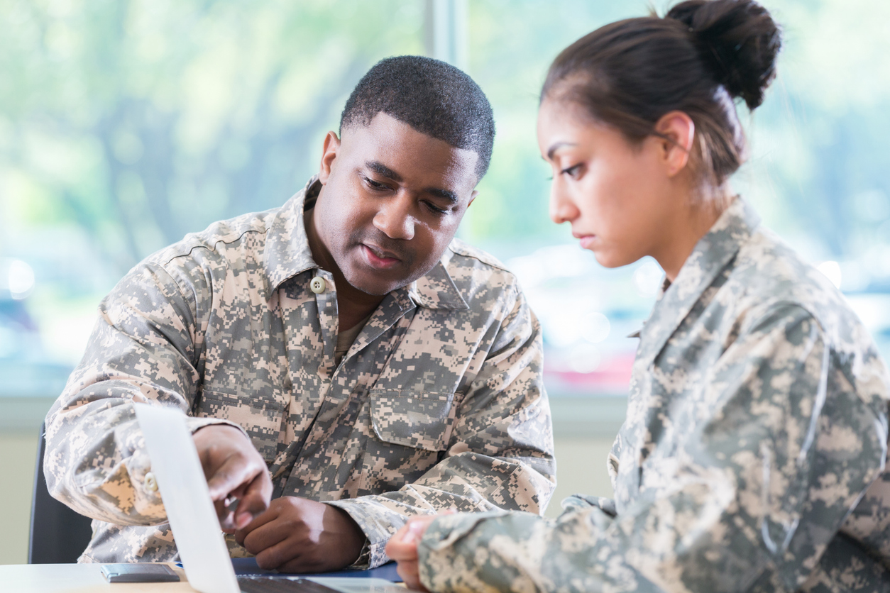 Two soldiers reviewing their benefits.