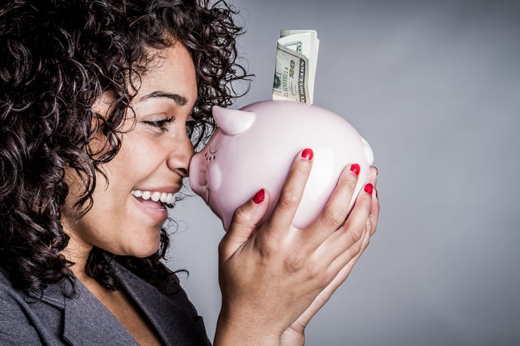 Happy saver holding a piggy bank